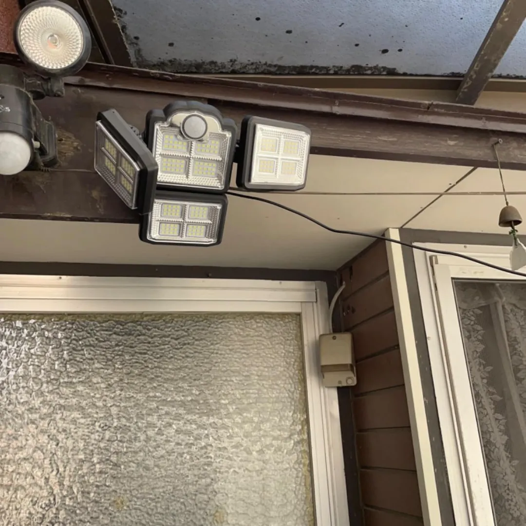 Adjustable 4 head solar motion sensor light installed at the door way
